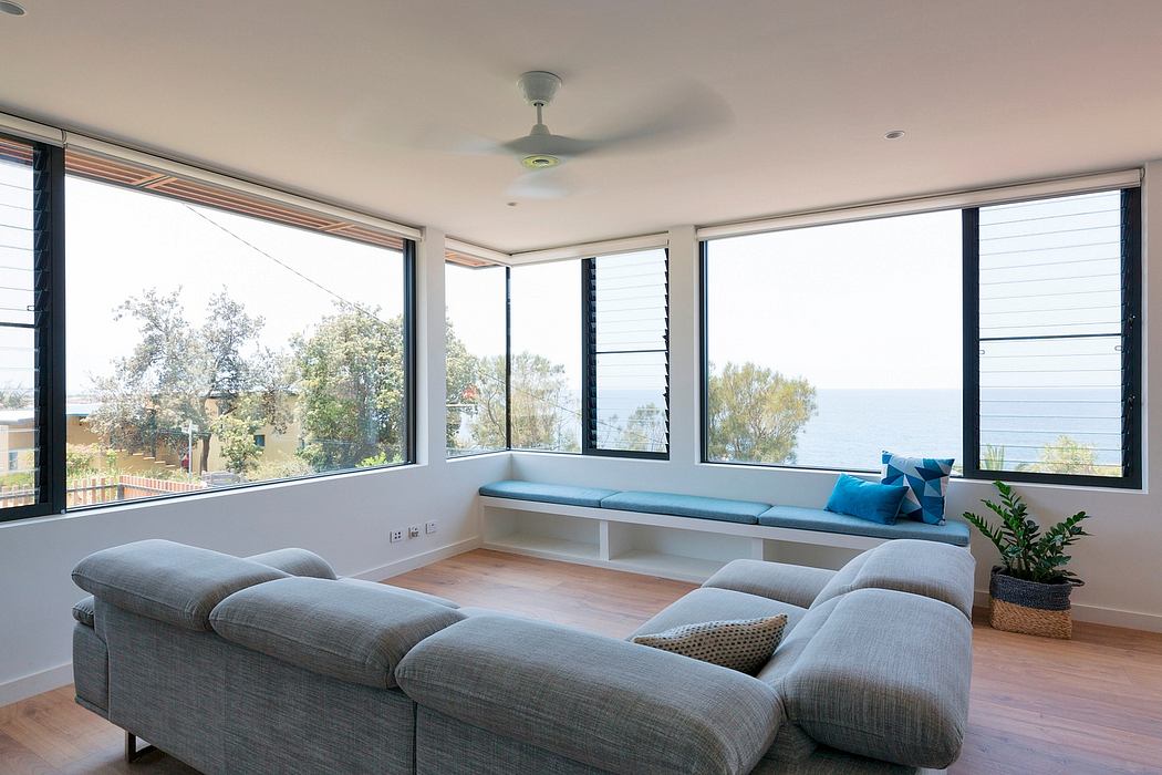Spacious and airy living room with large windows offering panoramic views of the outdoors.