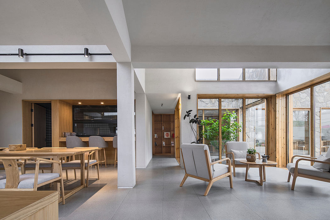 Spacious open-plan living area with wooden furniture, large windows, and modern decor.