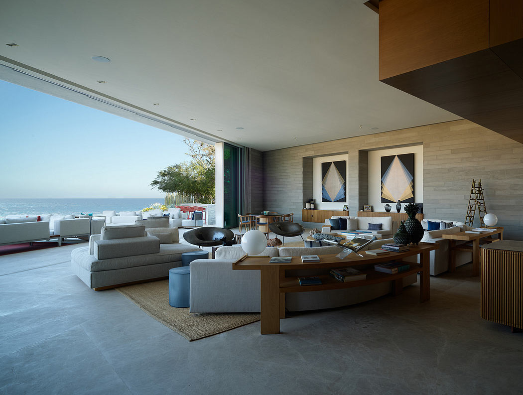 Spacious modern living room with large windows, neutral color palette, and minimalist decor.