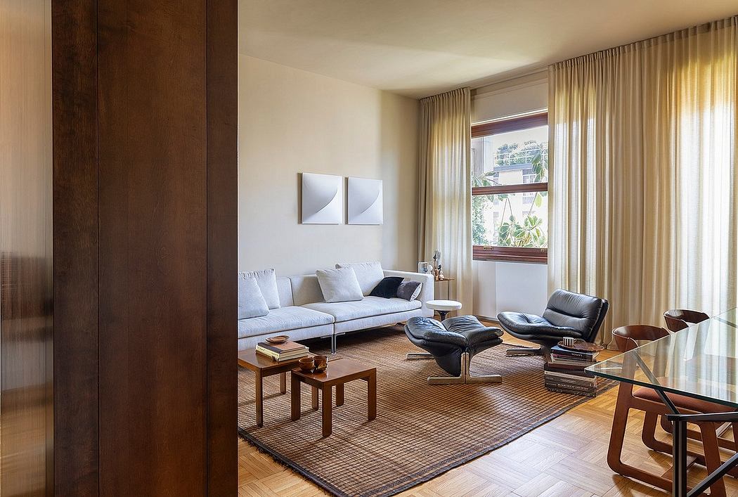 Relaxing living room with large windows, wooden furniture, and a comfortable sofa.