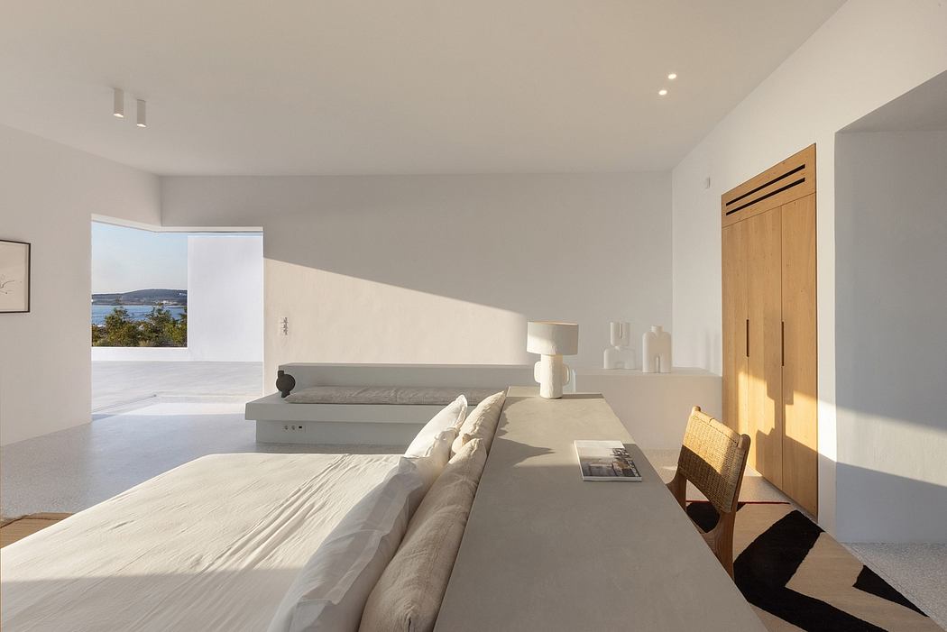 Elegant, minimalist bedroom with wooden accents, large windows, and serene outdoor view.