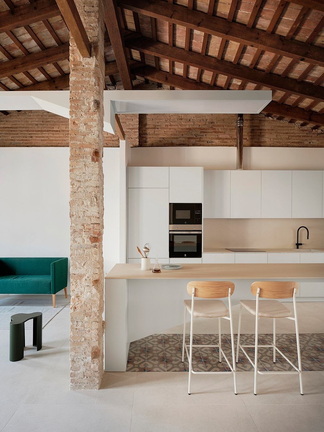 A modern kitchen with exposed brick walls, wooden beams, and sleek white cabinetry.