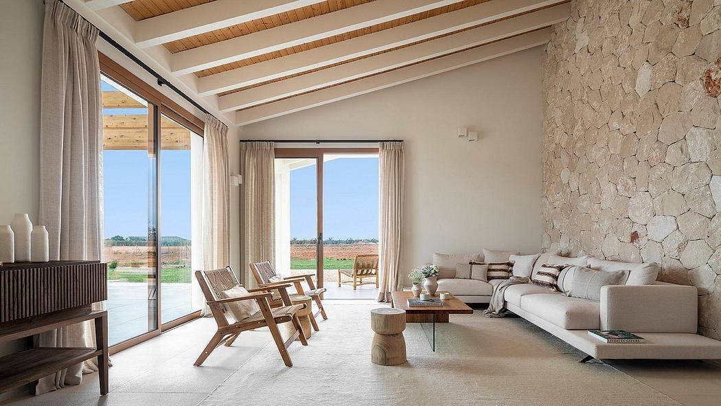 Spacious living room with wooden beams, stone walls, and floor-to-ceiling windows.