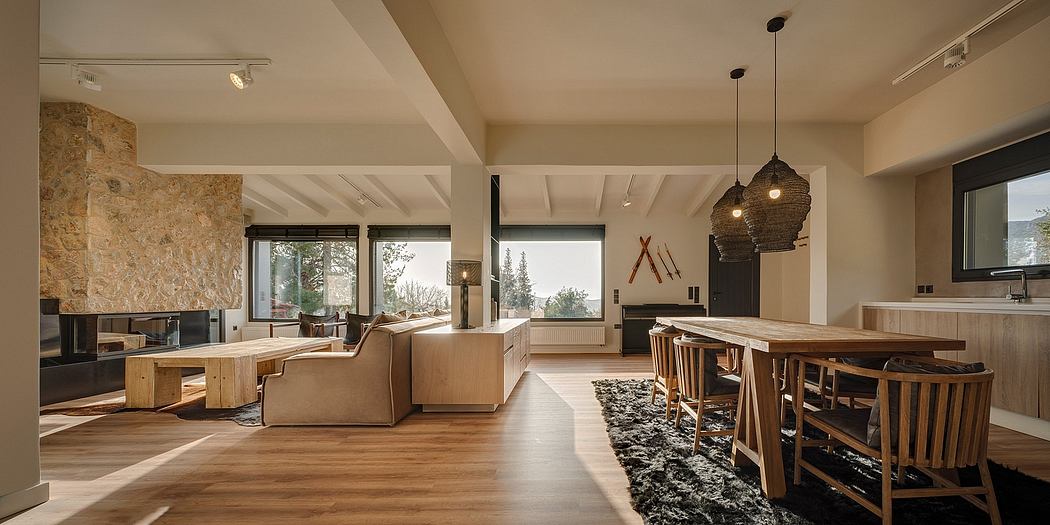 Spacious open-plan interior with exposed beams, large windows, and rustic stone accent wall.