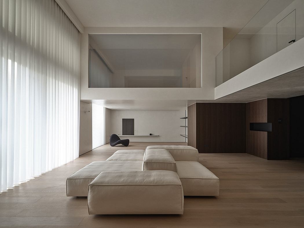 Expansive, minimalist living space with muted tones, modular furniture, and floor-to-ceiling windows.