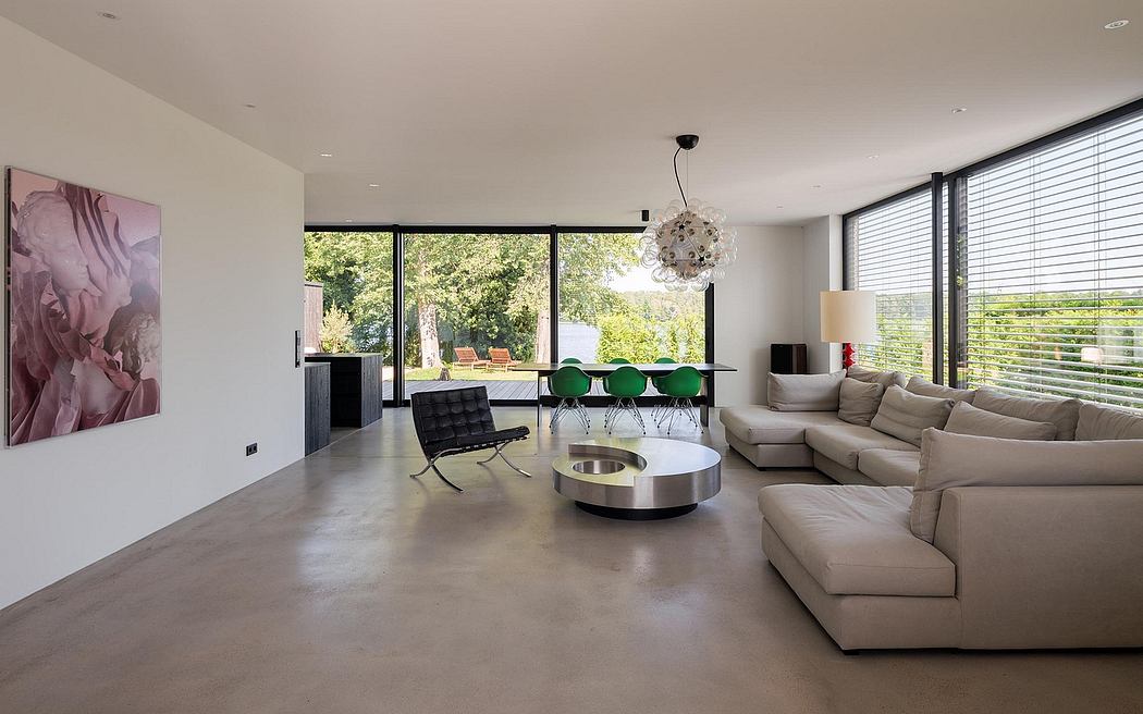 Spacious modern living room with sleek furniture, chandelier, and expansive windows.