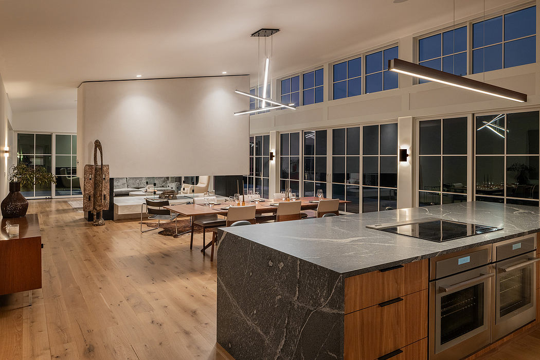Spacious contemporary kitchen with sleek countertops, modern lighting, and floor-to-ceiling windows.