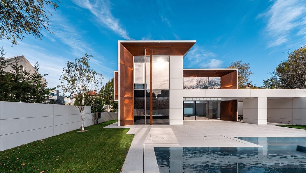Modern architectural masterpiece with striking copper accents, sleek lines, and a serene pool.