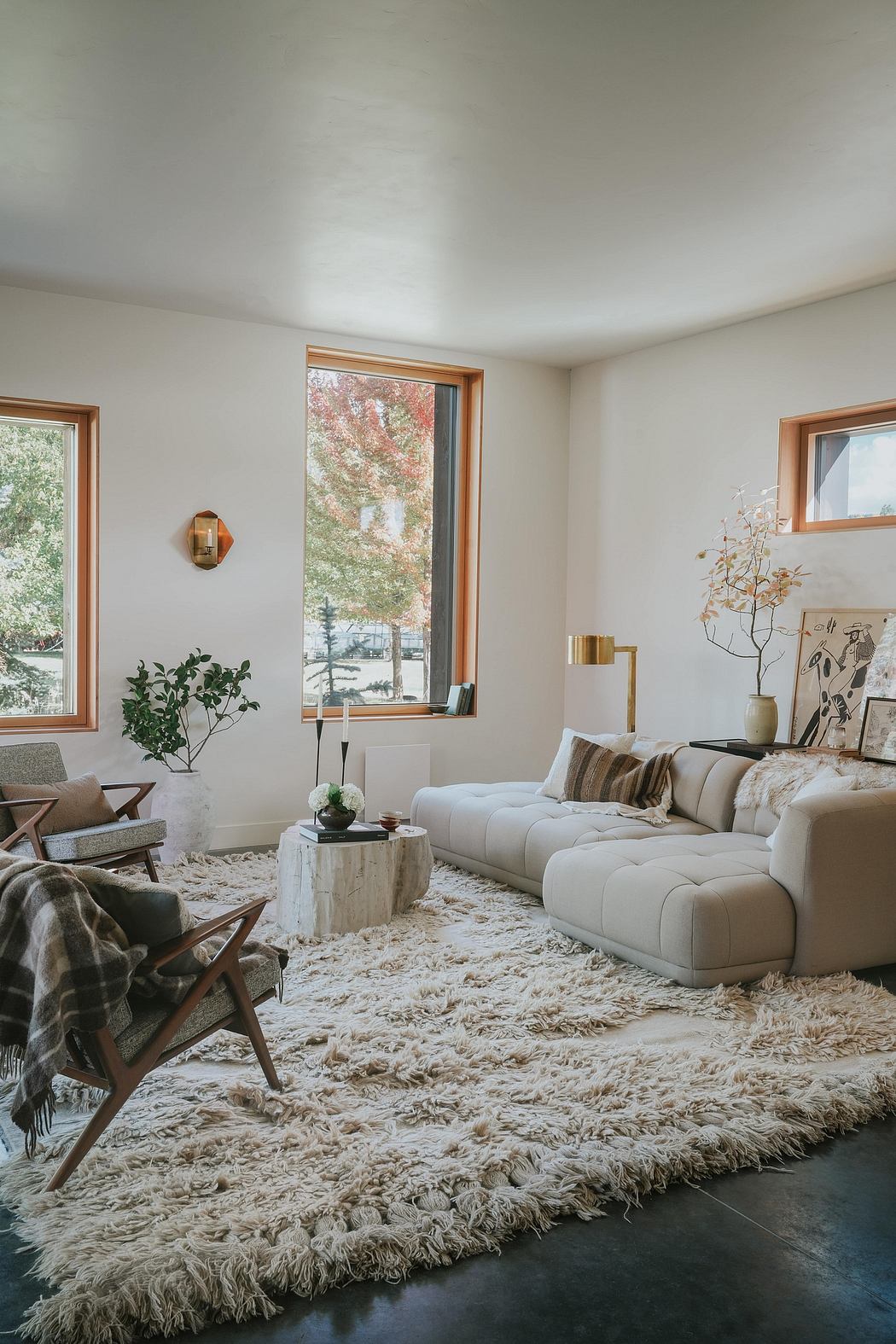 Cozy living room with plush furnishings, large windows, and nature-inspired decor.