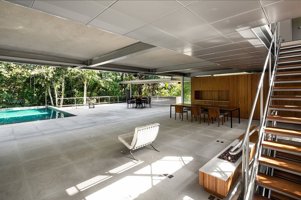 Sleek, modern outdoor space with pool, covered patio, and minimalist furnishings.