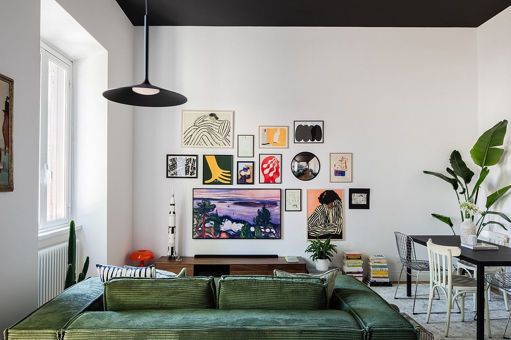 Colorful gallery wall with mixed media art, green velvet sofa, and eclectic furniture.