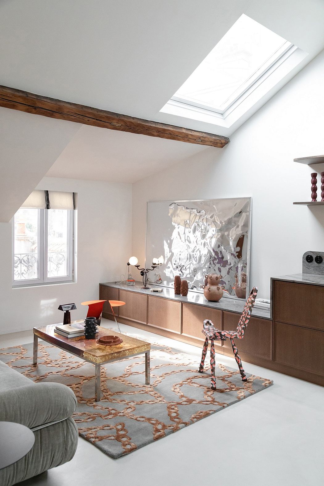 Bright, airy living room with exposed wooden beams, skylights, and contemporary decor.
