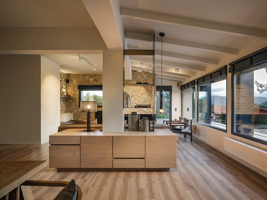 Large open-concept living area with wooden floors, stone walls, and contemporary furnishings.