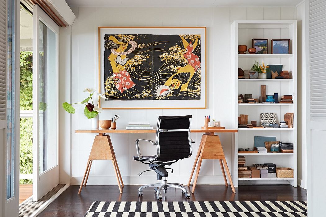 A modern home office with a large vibrant abstract art piece, wooden desk, and shelving.