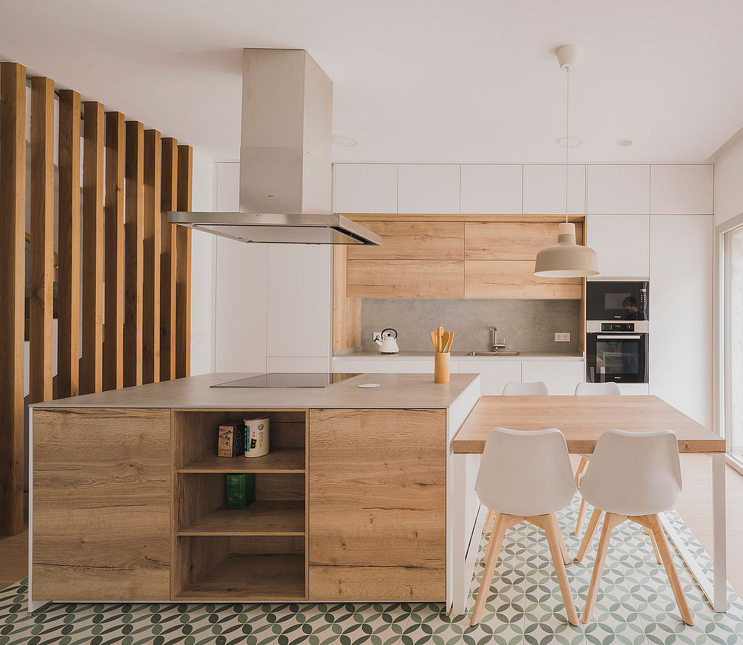 Minimalist kitchen design with wood-paneled walls, clean lines, and patterned floor tiles.