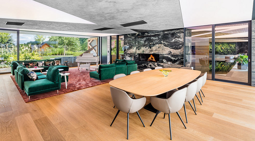 A modern open-plan living space with a large wooden dining table, sleek furniture, and a fireplace.