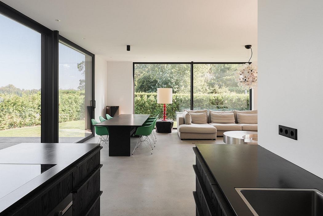 Spacious, modern living room with sleek furniture, large windows, and a dining area.