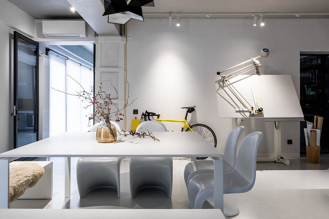 Sleek, modern interior with minimalist furnishings, pendant lighting, and a bicycle on display.
