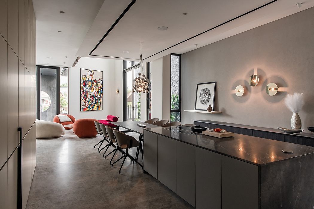 Sleek, modern interior with dark cabinetry, geometric lighting, and vibrant artwork.