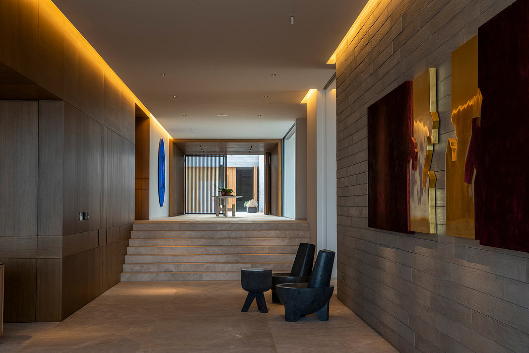 Elegant modern interior with sleek wooden walls, recessed lighting, and sculptural seating.