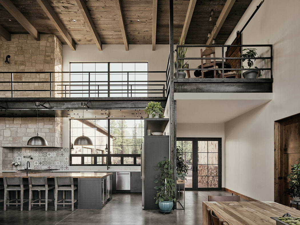 Modern open-plan kitchen with rustic wood beams, stone walls, and an industrial-style loft.