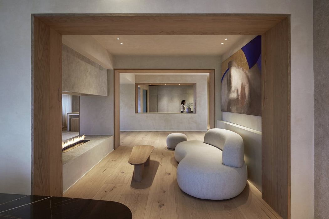 Spacious modern living room with warm wooden accents, plush seating, and minimalist artwork.