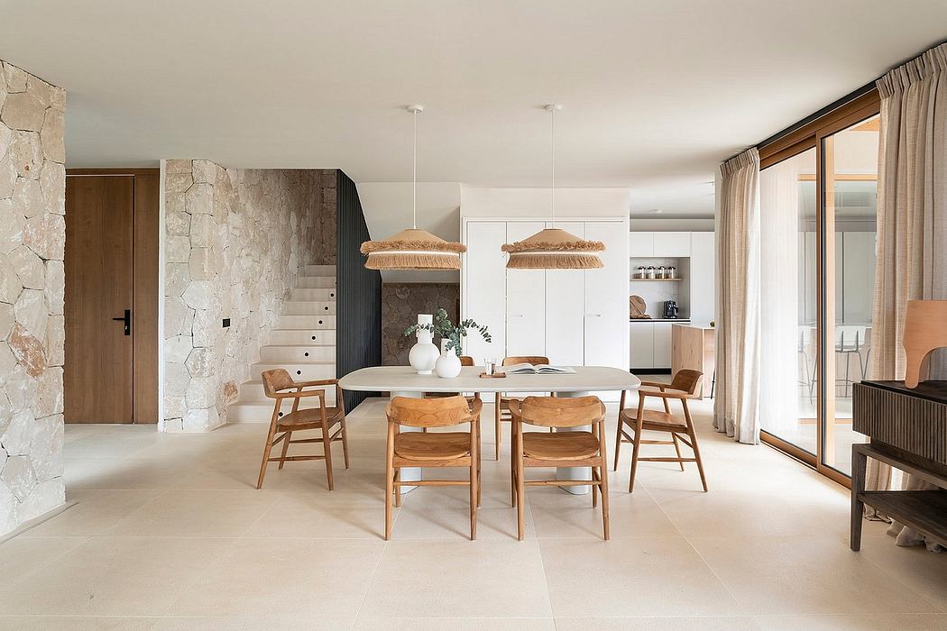 Spacious open-plan living area with stone walls, wooden furniture, and natural lighting.