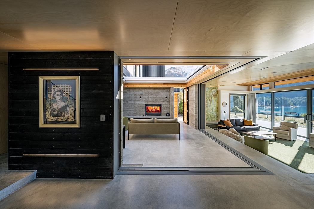 Spacious modern living area with large windows, fireplace, and artwork on the wall.