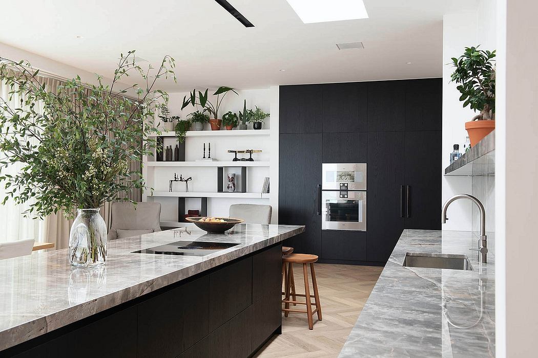 Sleek, modern kitchen with black cabinetry, marble countertops, and built-in shelving.