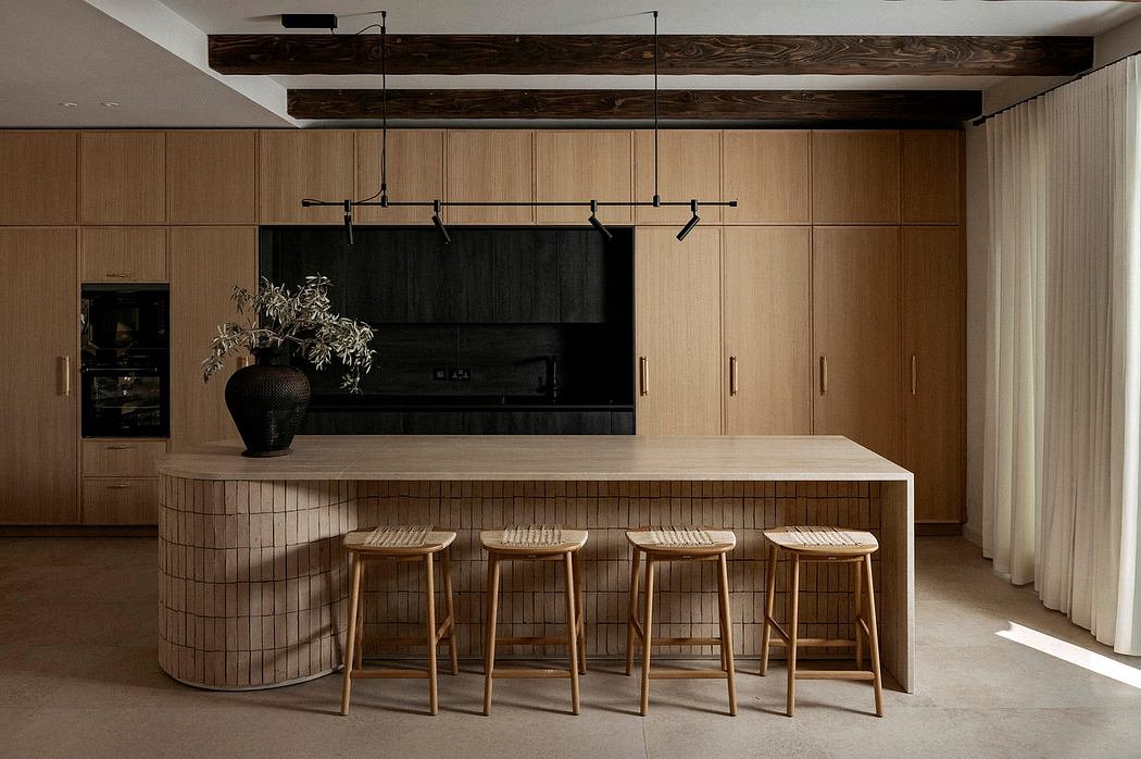 Minimalist kitchen with warm wood tones, tile-lined countertop, and modern lighting fixtures.