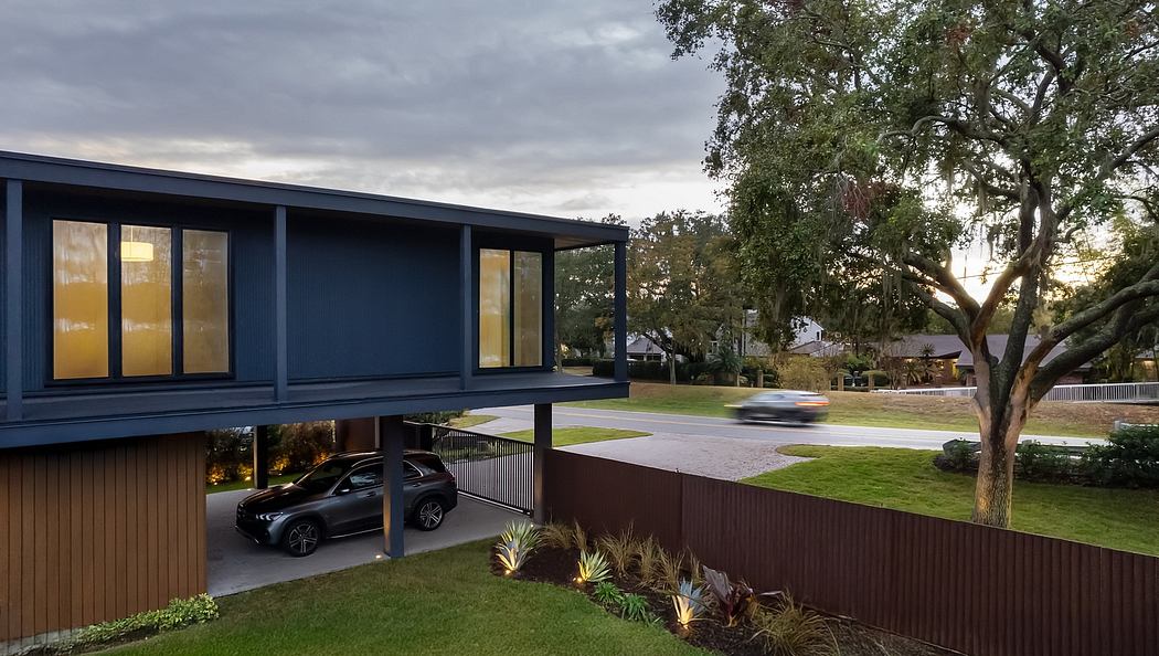 Sleek modern home with oversized overhanging roof, large windows, and lush landscaping.