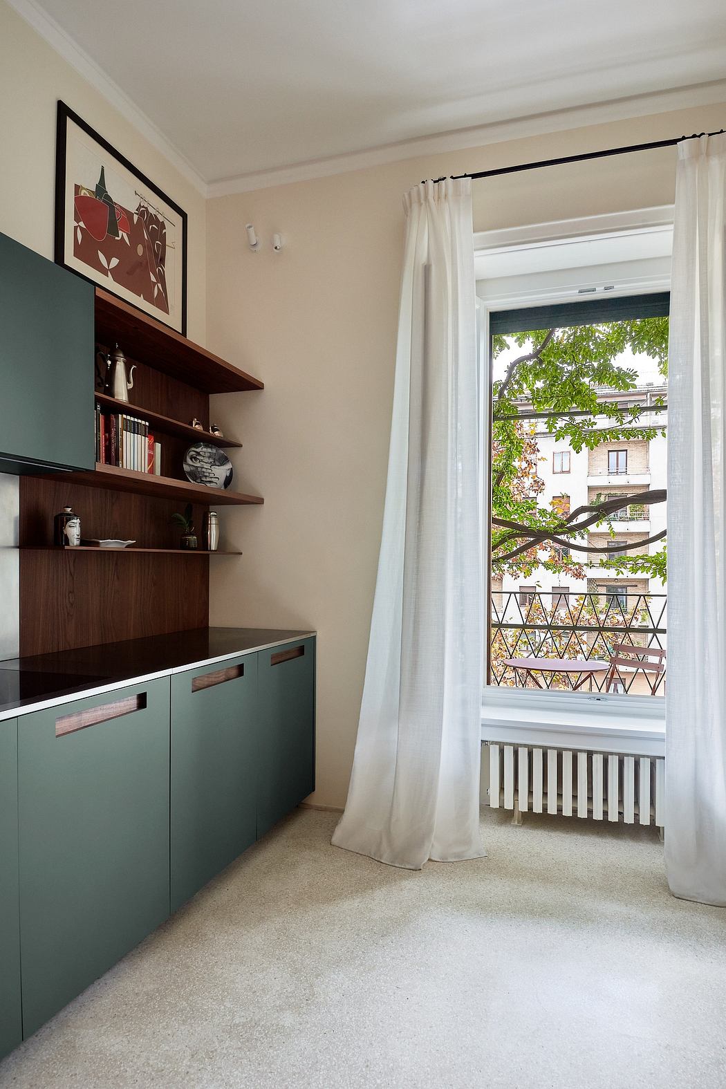 A cozy room with green shelves, white curtains, and a view of the trees outside.