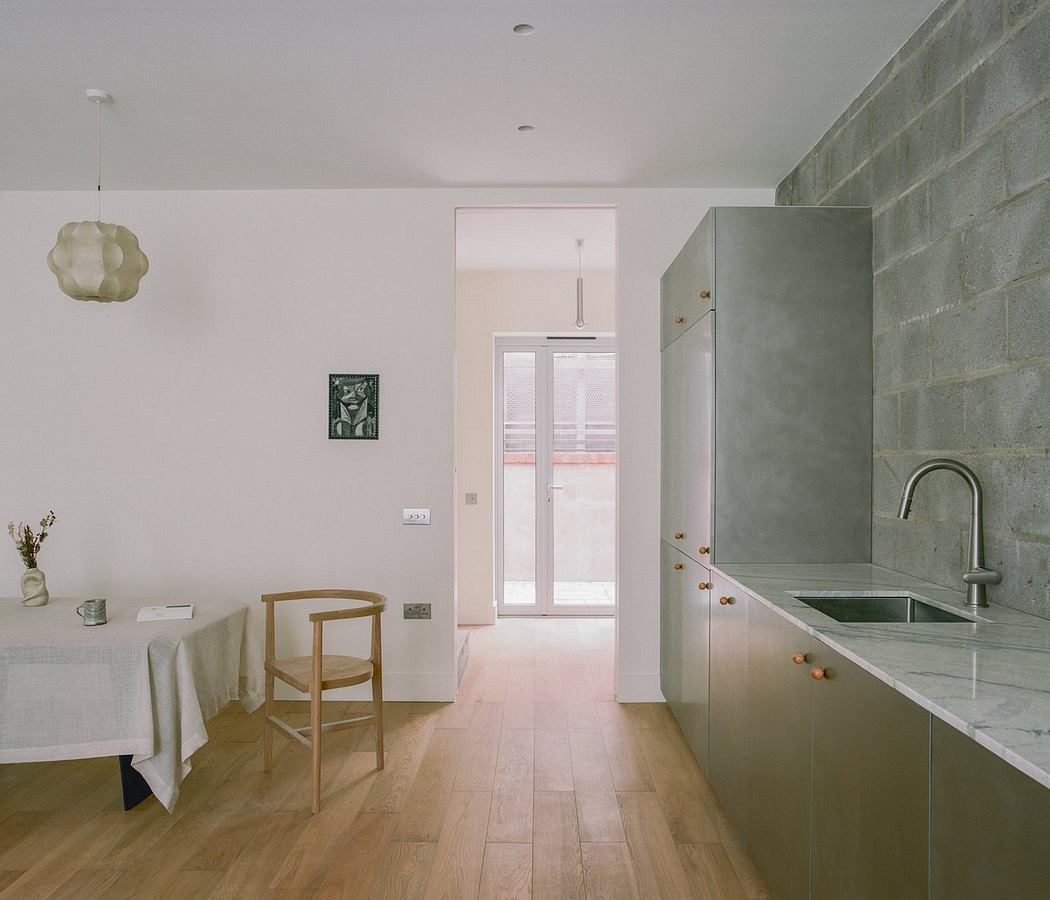 A modern kitchen with minimalist concrete and wood design elements.
