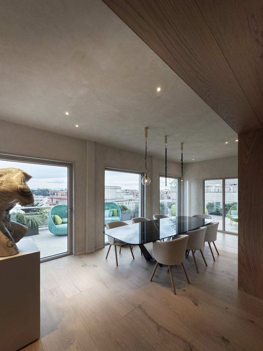 Spacious, modern dining area with large windows, sleek table, and stylish lighting.