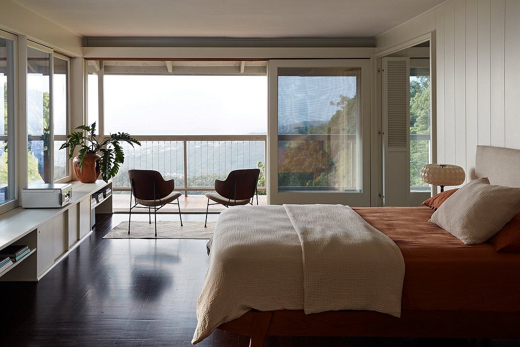 Spacious bedroom with floor-to-ceiling windows, plush bedding, and modern furnishings.
