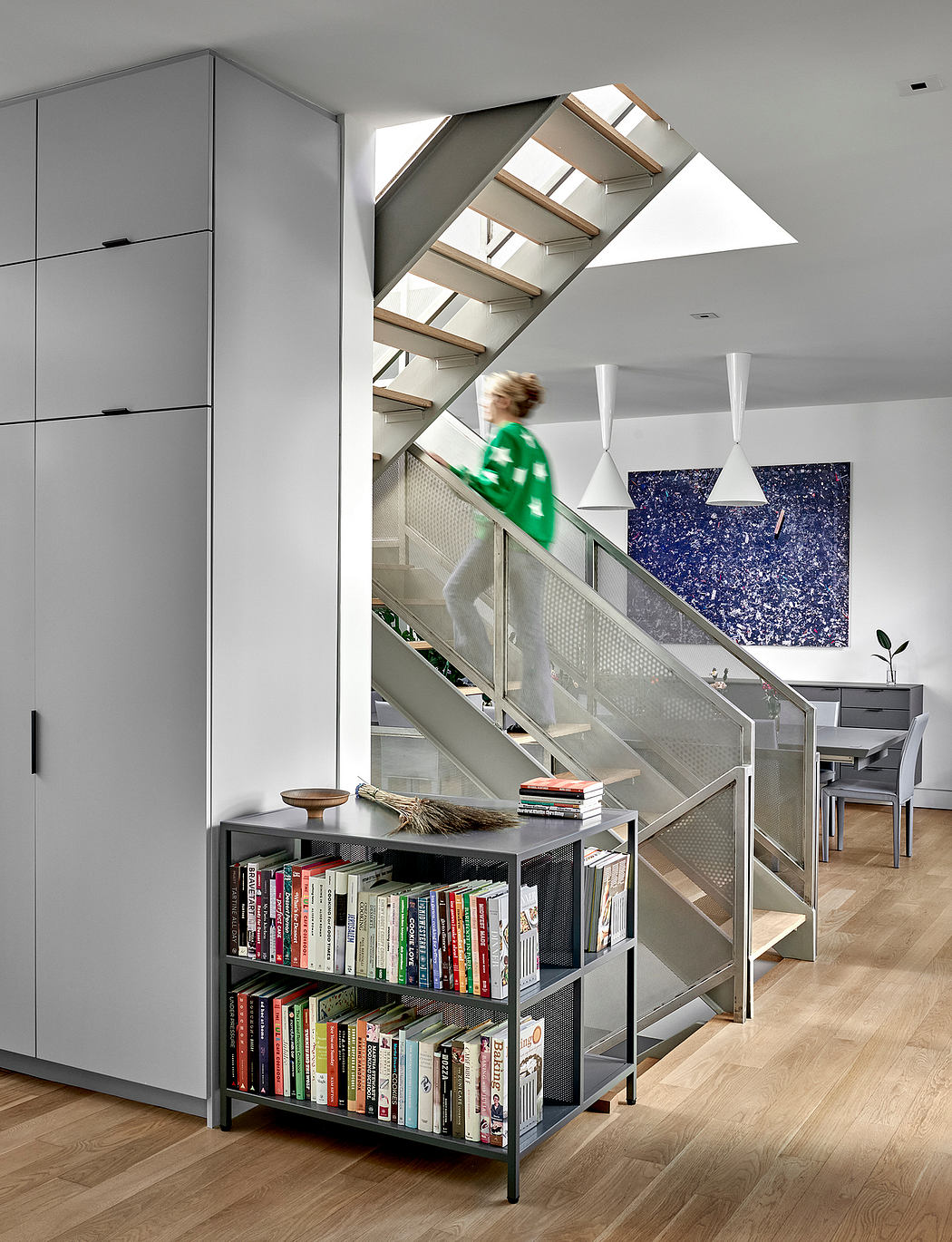 Striking staircase with wood and glass, complementing the modern, minimalist interior.