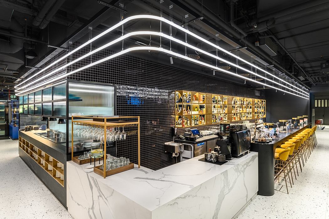 A modern, sleek café interior with geometric lighting, black mesh panels, and marble countertops.