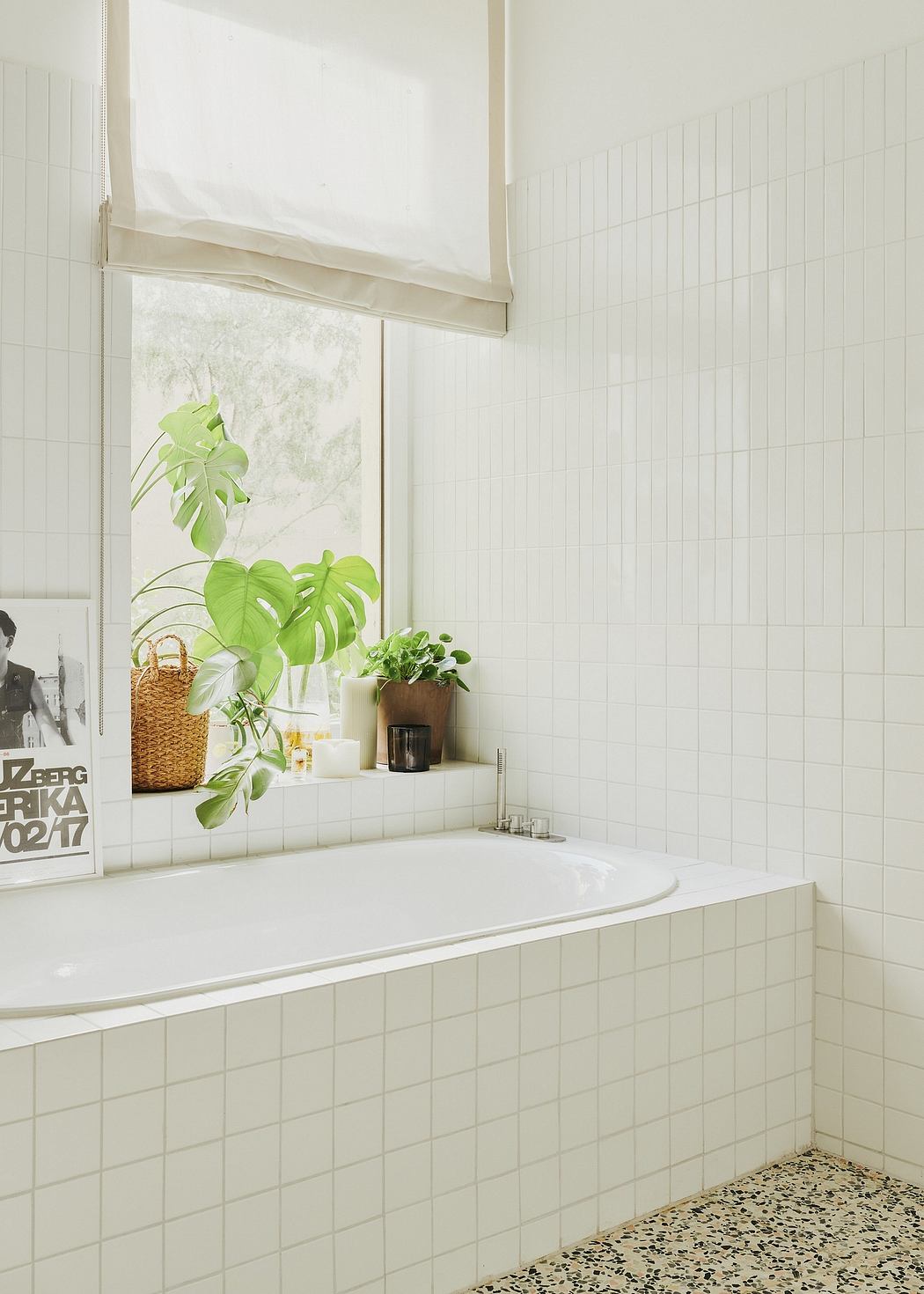 Serene bathroom with lush greenery, terrazzo flooring, and minimalist decor.