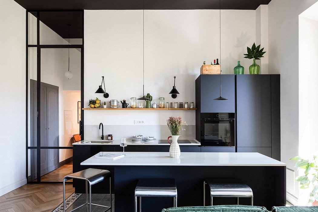 Modern, minimalist kitchen with sleek black cabinetry, open shelving, and white countertops.
