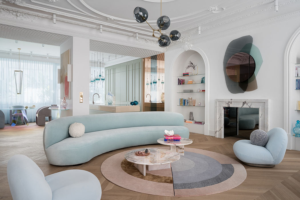 Elegant, modern living room with curved sofa, sculptural lighting, and decorative shelving.