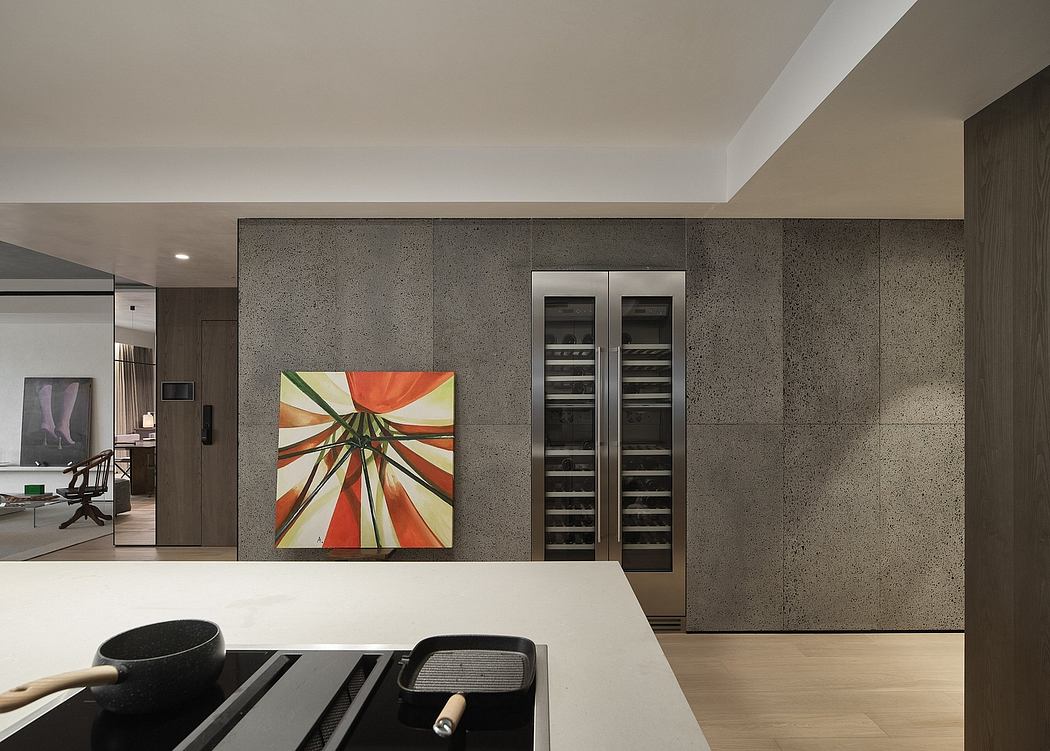 Modern kitchen with gray concrete walls, built-in wine fridge, and vibrant abstract art.