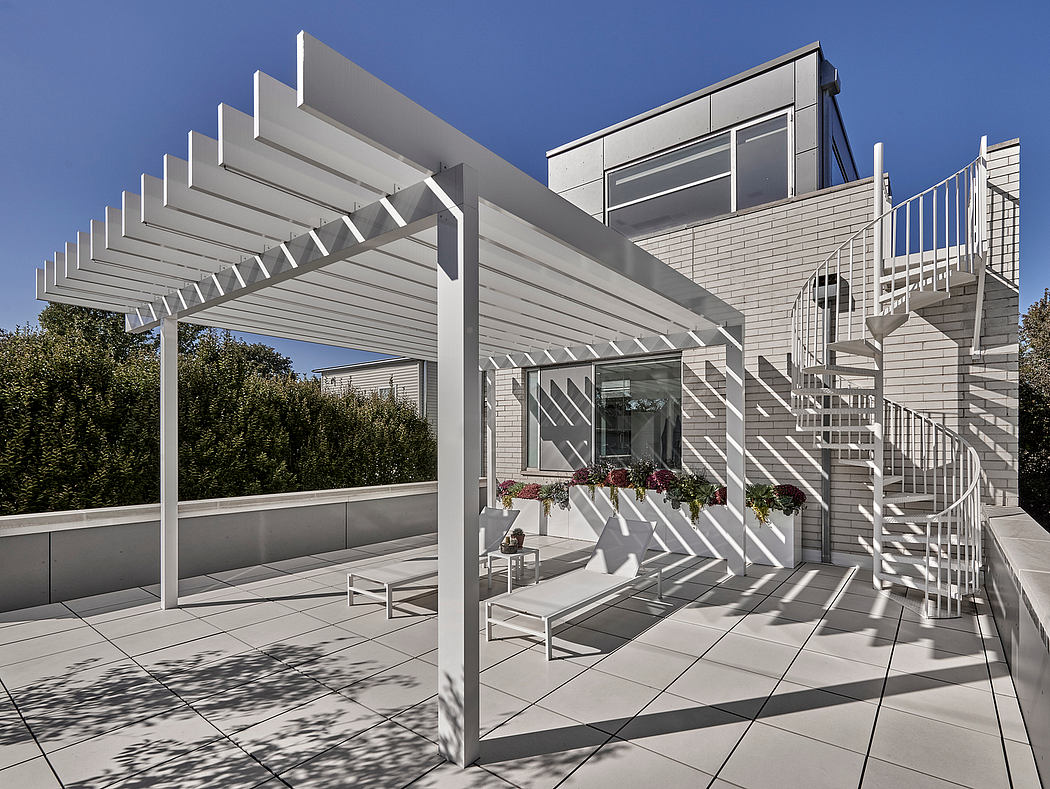 Modern architectural design with tiered pergola, spiral staircase, and tiled patio.