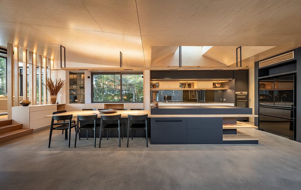 Spacious open-plan kitchen-dining area with sleek, minimalist design elements.