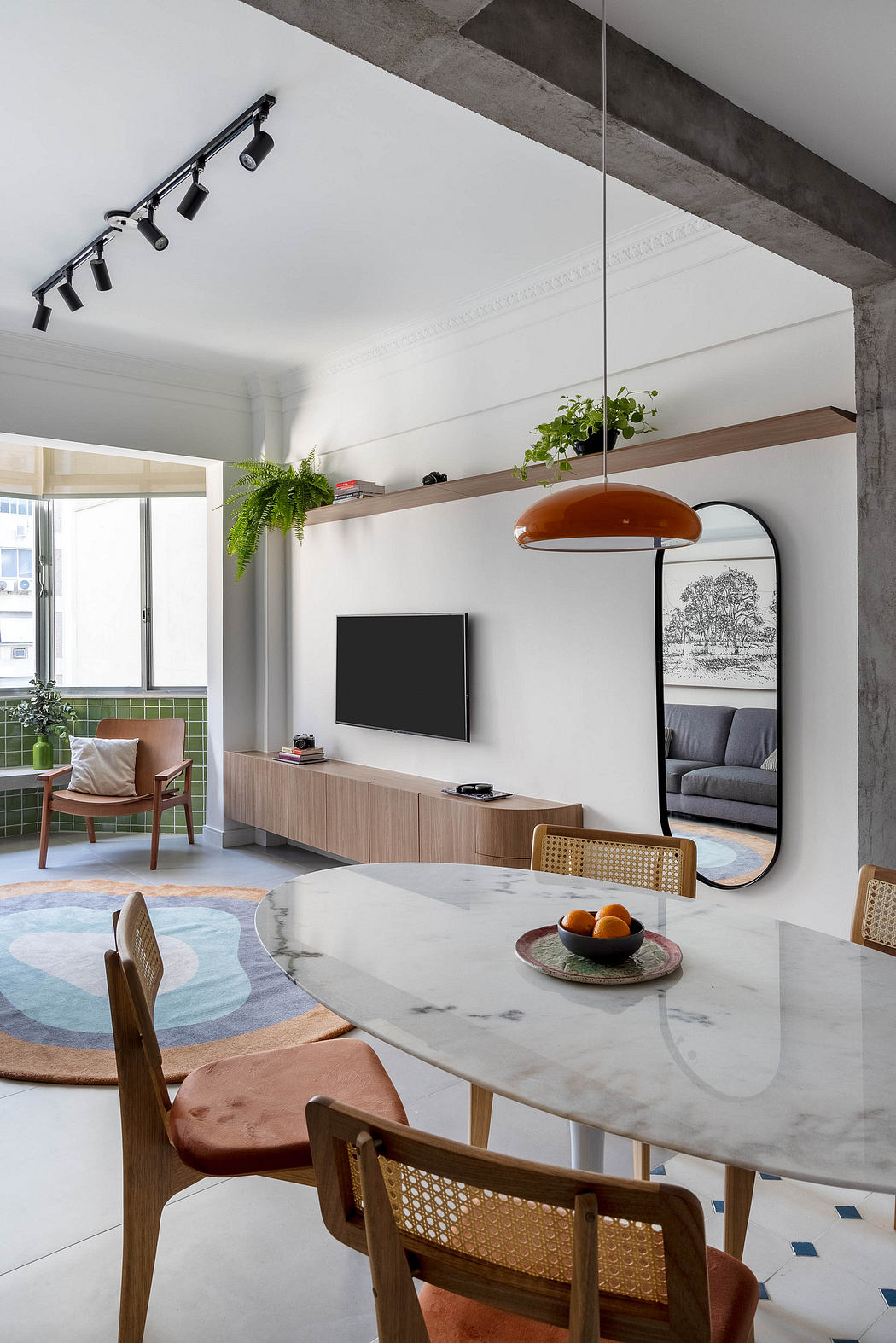Modern living space with marble dining table, wooden furniture, and greenery accents.