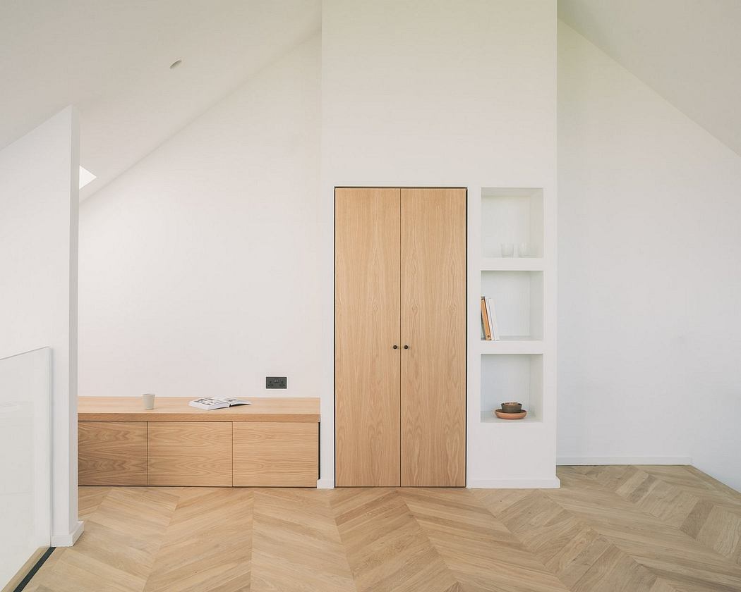 Minimalist room with wood furniture, shelving, and herringbone-patterned floor.