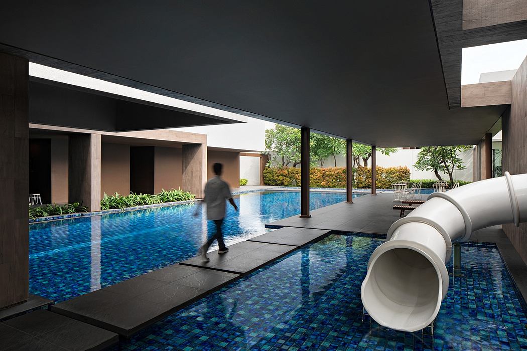 Striking modern indoor pool with sleek architecture, glass walls, and slate-colored stepping stones.