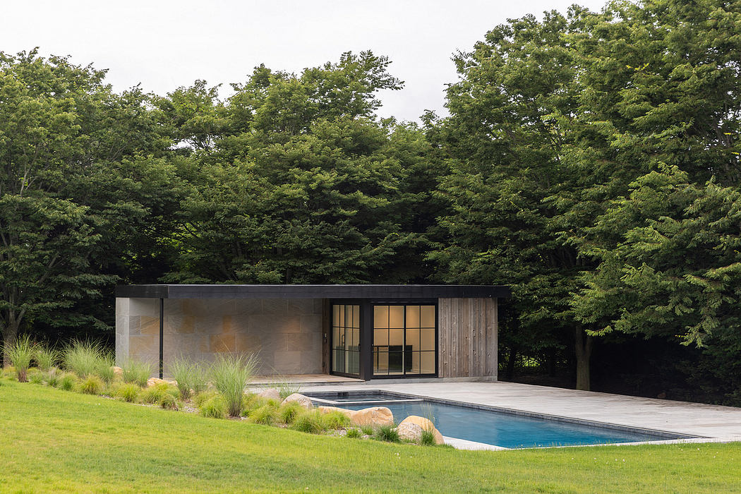 A modern pool house with a sleek, minimalist design, surrounded by lush greenery.