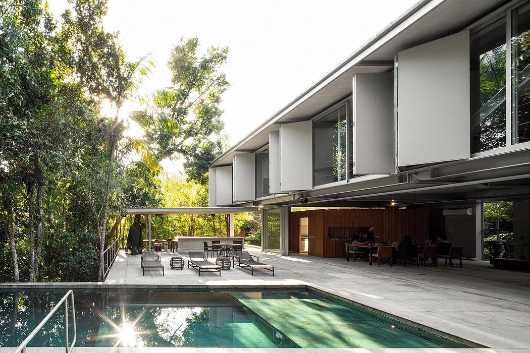 Mid-century modern home with sleek exterior, expansive outdoor living area, and a pool.