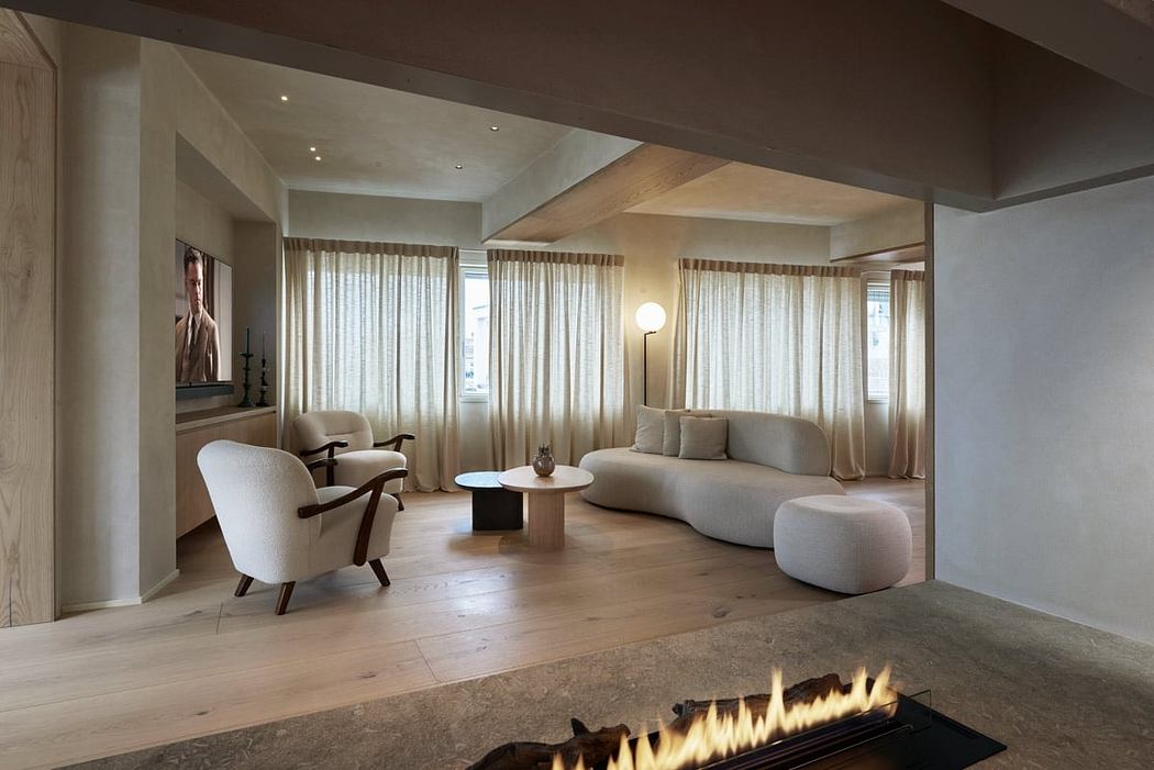 Spacious living room with fireplace, plush seating, and floor-to-ceiling windows creating a cozy ambiance.