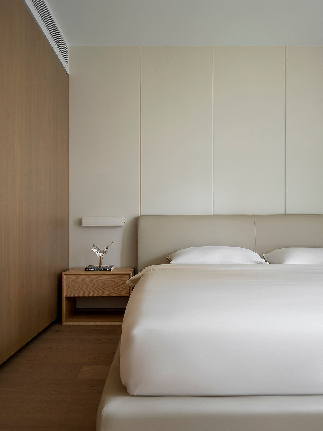 Minimalist bedroom design featuring clean lines, neutral tones, and wood accents.